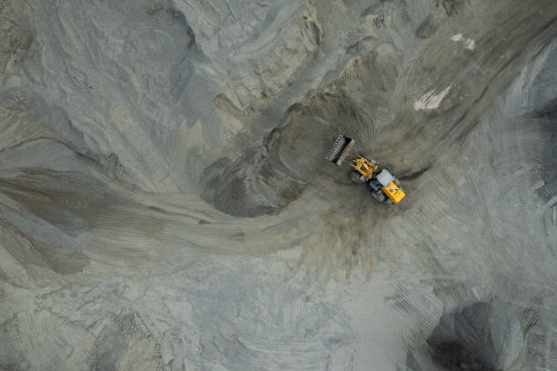 istock Sand loaders are shoveling rocks into dump trucks. 1564156262