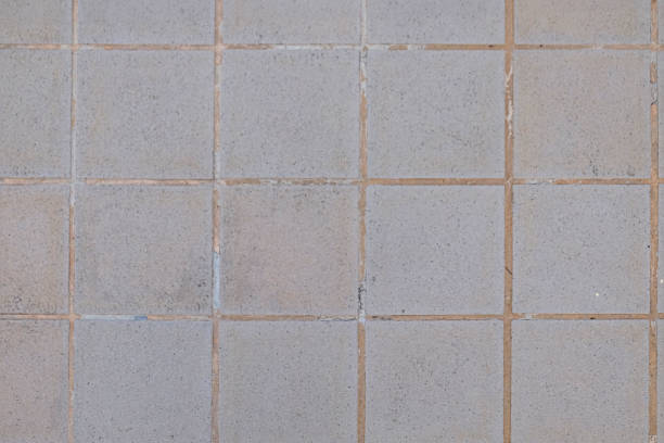 istock a close up of a tile floor with a white wall 1564196532