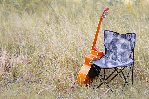 Guitars, camping, such as stoves, chairs, on sunny days outdoors. outdoor romantic hippie