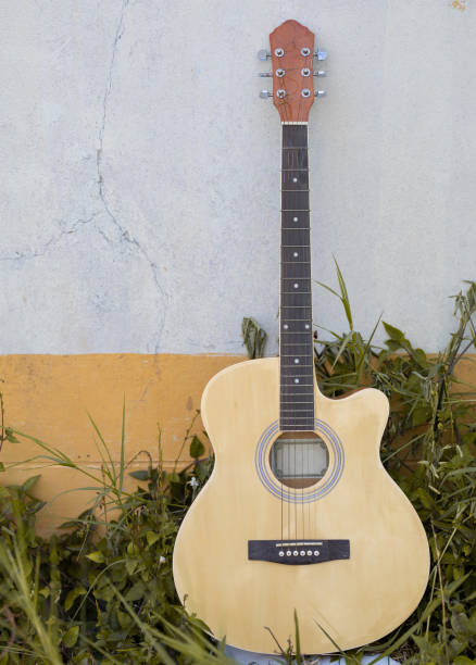 istock guitar on old wall, copy spaced,vintage tone. 1564221978
