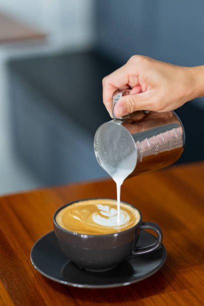 istock closeup hand doing hot latte art coffee 1564223575