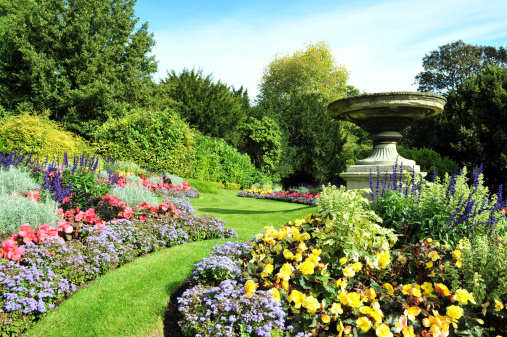 Flowerbeds, Grass Pathway and Ornamental Vase in a Formal Garden