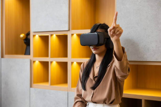 istock Asian young female using virtual reality headset. VR Glasses gadgets new technology for lifestyle 1564269690