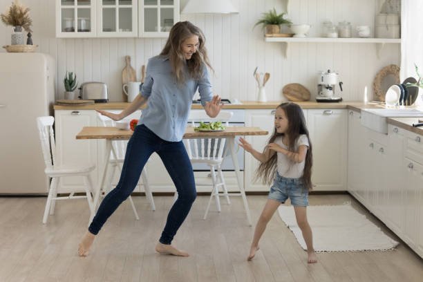 istock Positive active young mother dancer teaching little kid to dance 1564282426