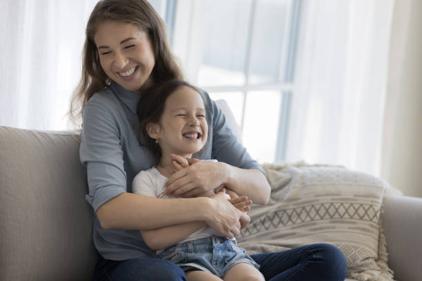 istock Joyful happy mummy cuddling cheerful little kid 1564282962