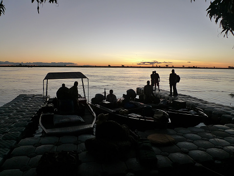 Unrecognizable people at the end of  long day of boating on the Zambezi River