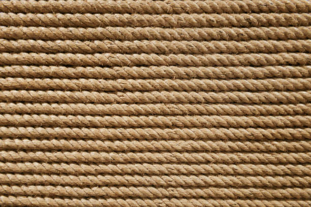 Brown beige grungy round twisted strong rope from nautical industry material craft pattern textured background