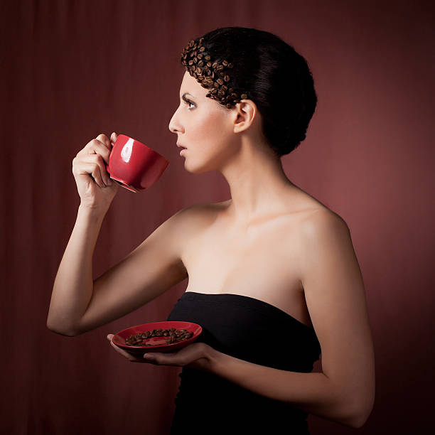 Beautiful young woman drinking coffee stock photo