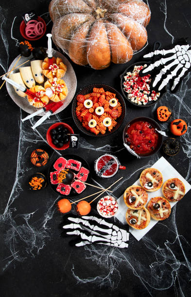 istock Halloween sweets for Halloween party on black background. top view 1564382409