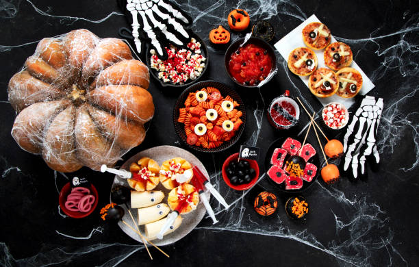 istock Halloween sweets for Halloween party on black background. top view 1564382414