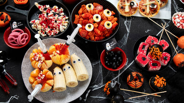 istock Halloween sweets for Halloween party on black background. top view 1564384531