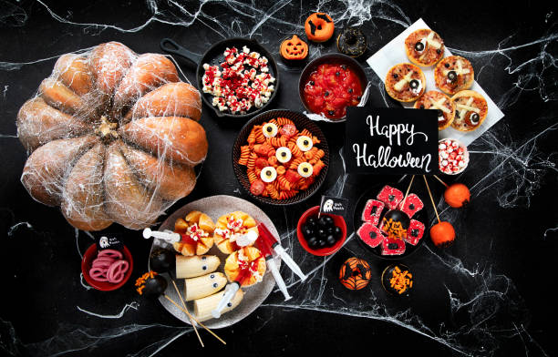 istock Halloween sweets for Halloween party on black background. top view 1564388401