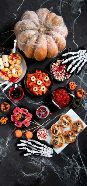 istock Halloween sweets for Halloween party on black background. top view 1564388747