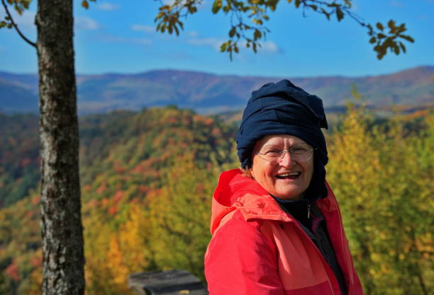 istock Senior woman  with autumn forest in background 1564390054