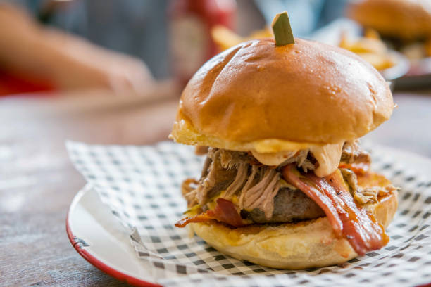 istock Close up of Bacon and Cheese Burger on plate 1564411709