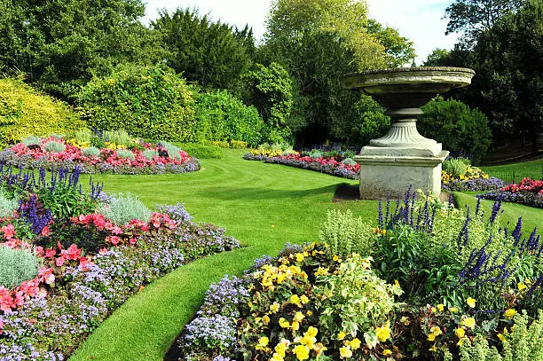 Flowerbeds, Grass Pathway and Ornamental Vase in a Formal Garden