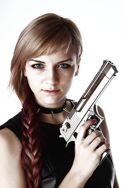 istock girl holding gun 156443140