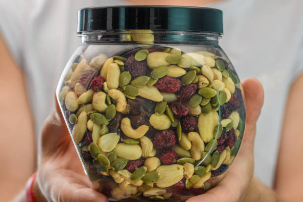 istock A mixture of various nuts and dried fruits held in the hands in a plastic container 1564462243