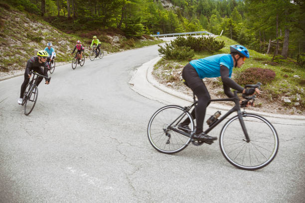 Cyclists on a hairpin curve stock photo