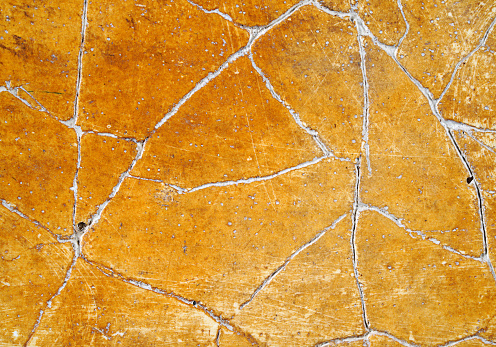 Cracked bright orange plaster background texture
