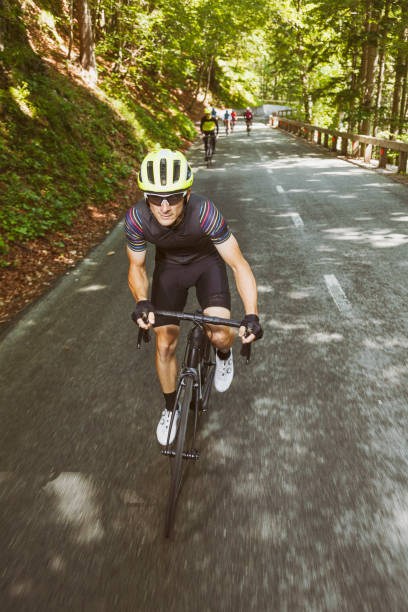 istock Bicycle rider in front of his friends 1564524683