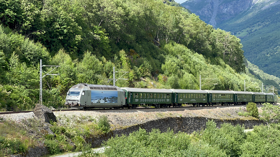 Myrdal, Norway - July 12 2023: The Flamsbana electric train making its way up from Aurlandsfjorden towards the mountain station