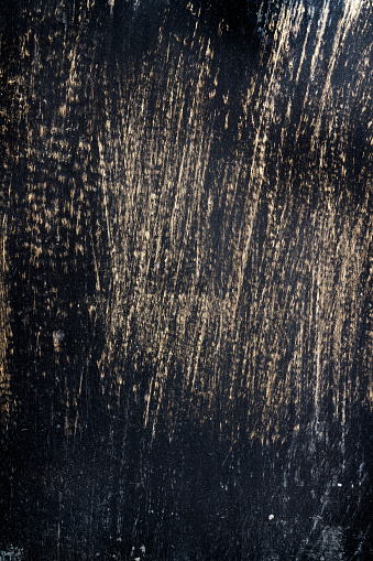 Scratched black and gold metallic background texture