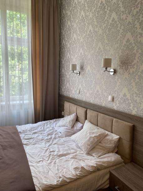 istock bed in a hotel room, hotel room interior 1564534254