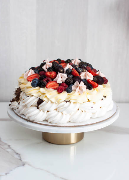 istock Pavlova cake with whipped cream cheese, chocolate sauce and fresh berries on grey background 1564583523