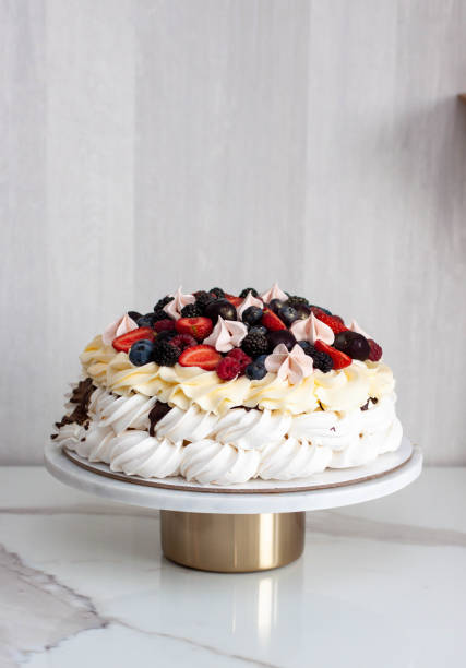 istock Pavlova cake with whipped cream cheese, chocolate sauce and fresh berries on grey background 1564583535