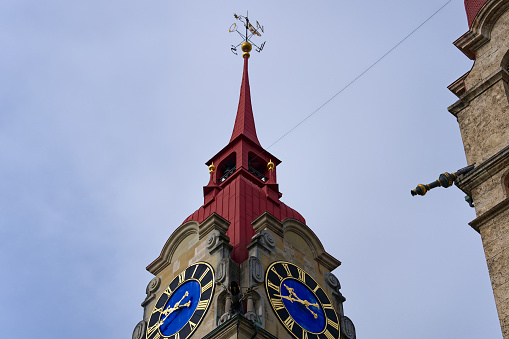 Close-up of church tower with clock face of protestant church at the old town of Swiss City of Winterthur on a cloudy spring day. Photo taken May 17th, 2023, Winterthur, Switzerland.