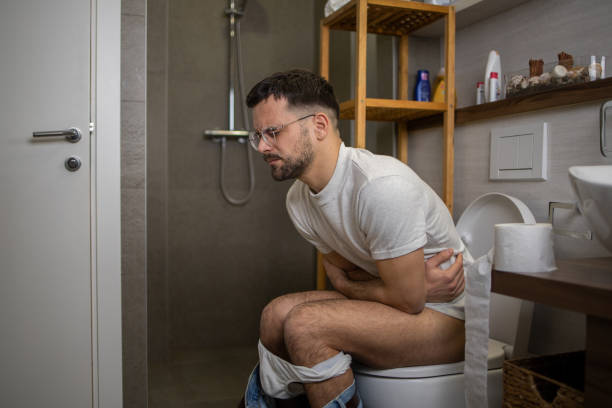 istock Man sitting on toilet 1564599632