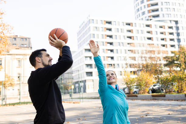 istock Young happy couple on a basketball training 1564602321