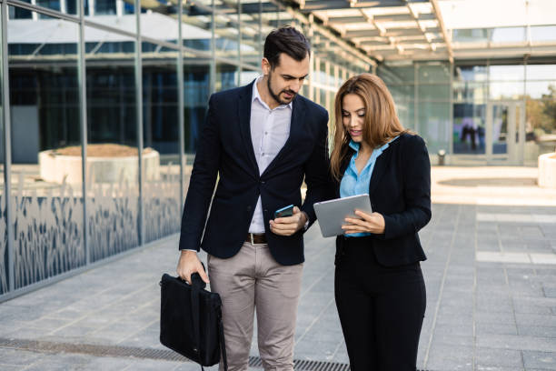 istock Business partners walking and discussing business 1564603388