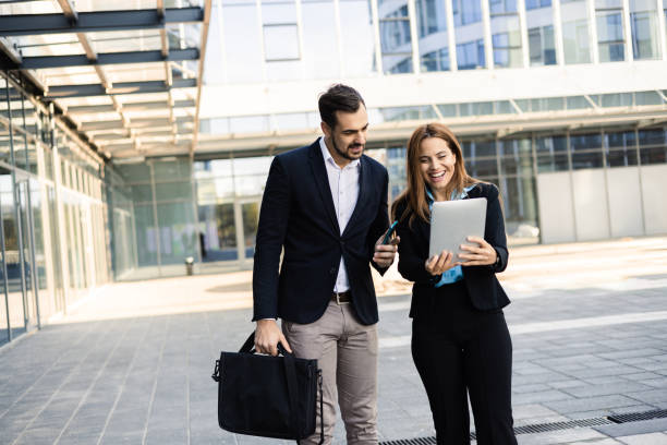 istock Business partners walking and discussing business 1564603391