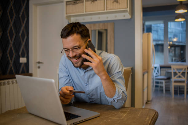 istock Man using his credit card to shop online 1564605001