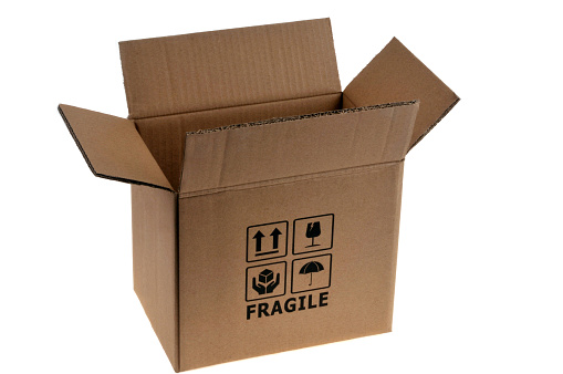 Open empty cardboard box with fragile written on it close up on white background