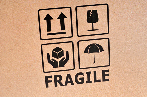 Fragile written on a cardboard close up