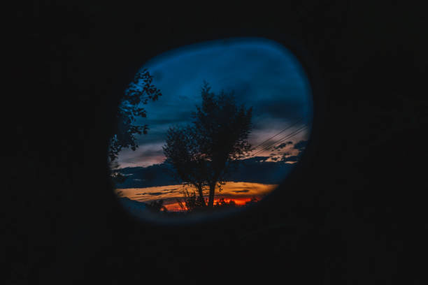 istock Dramatic orange clouds in the sky during sunset - Clouds in the sky background - Reflection in rear mirror 1564648844
