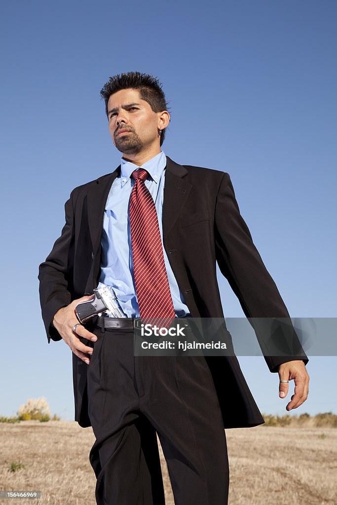 Uomo d'affari puntando la pistola - Foto stock royalty-free di Adulto
