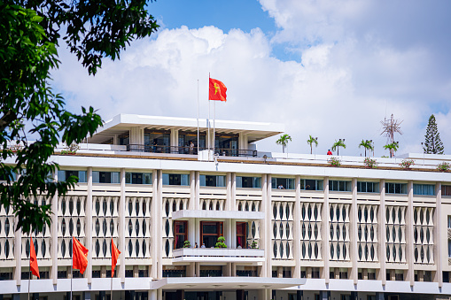 Ho Chi Minh, Viet Nam - 30 June 2023: Beautiful morning of front View Reunification Palace, which was a work of president and government to recognize national historic sites in Ho Chi Minh City, Vietnam