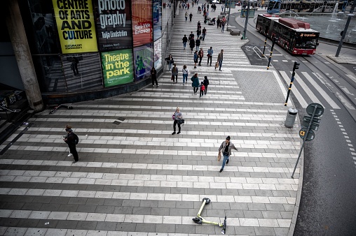 Stockholm, Sweden – June 18, 2022: A high angle shot of people walking around on the streets of Stockholm, Sweden