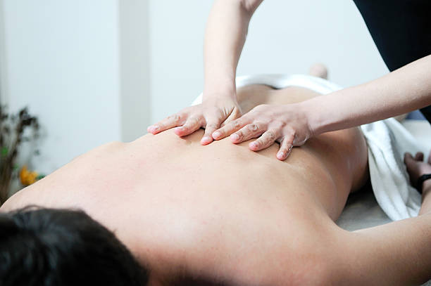 istock Young man enjoying massage at spa 156470044