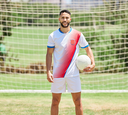 Fitness, sports and soccer player portrait on a football field ready to play a soccer match or training game. Healthy, smile and happy athlete on a grass pitch for a cardio exercise and workout