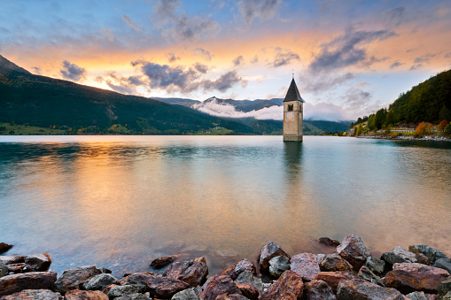 The famous bell tower in the Lake of Reschen (Reschen See - Lago di Resia) in Südtirol, Italy. During WW2 a dam was build and put the village under water, only the tower is still visible now. 