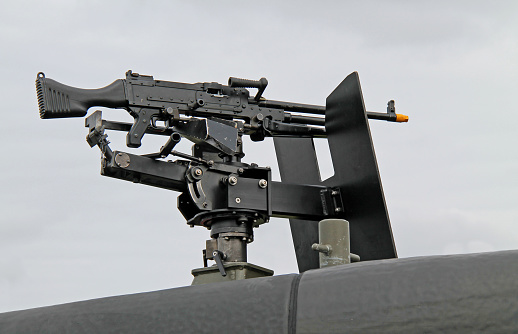 A Machine Gun Mounted on the Top of a Military Vehicle.