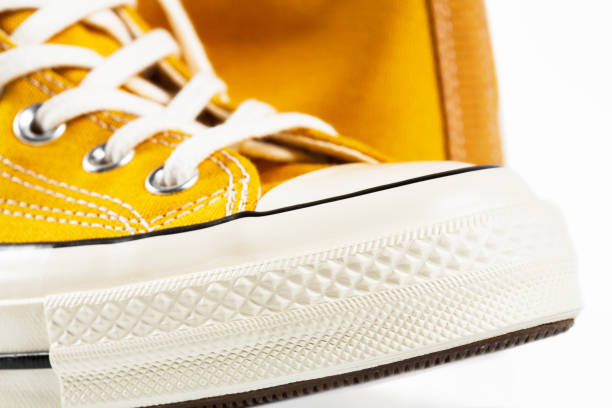 istock Yellow sneakers on white background with copy space. Youth shoes. 1564732599