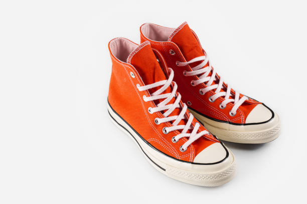 istock Red sneakers on white background with copy space. Youth shoes. 1564734728