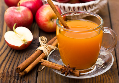 A cup of warm apple cider with cinnamon