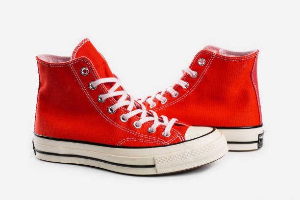 istock Red sneakers on white background with copy space. Youth shoes. 1564735604